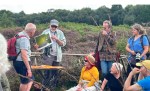Mick Wright holding up a an image of bird at Drummin bog